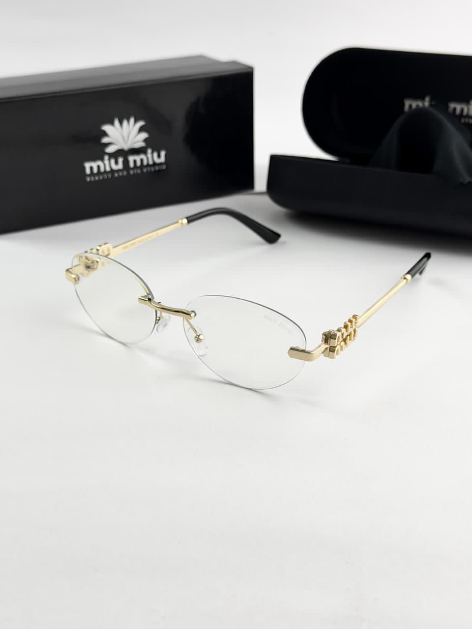 MIU MIU gold frame 1025